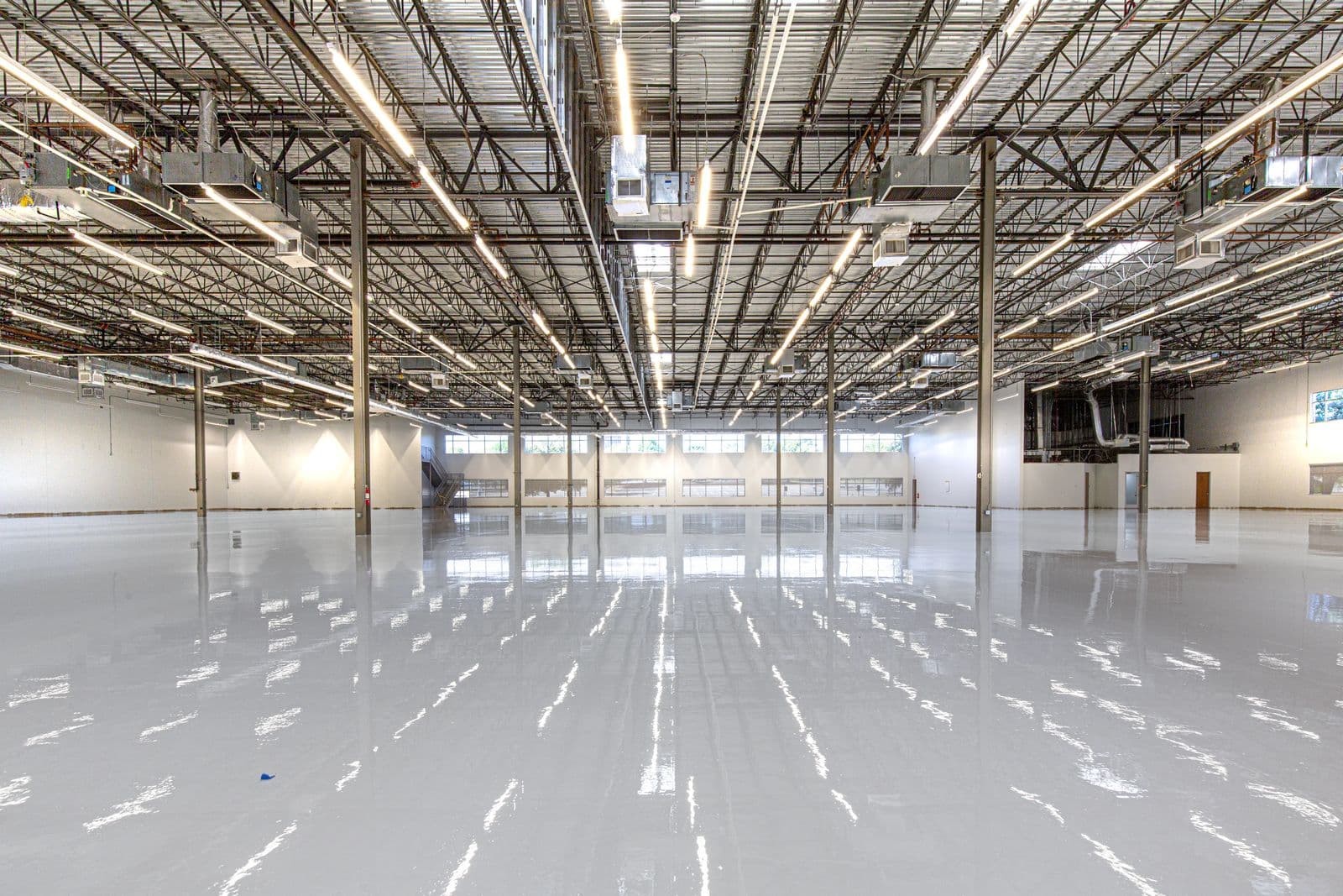 Gloss epoxy floor finish reflecting overhead lighting
